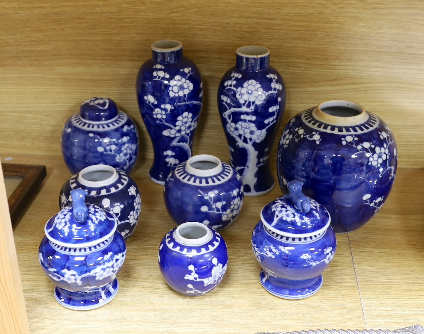 A group of Chinese blue and white prunus vases and jars and covers and jars, pair of vases 23 cms high
